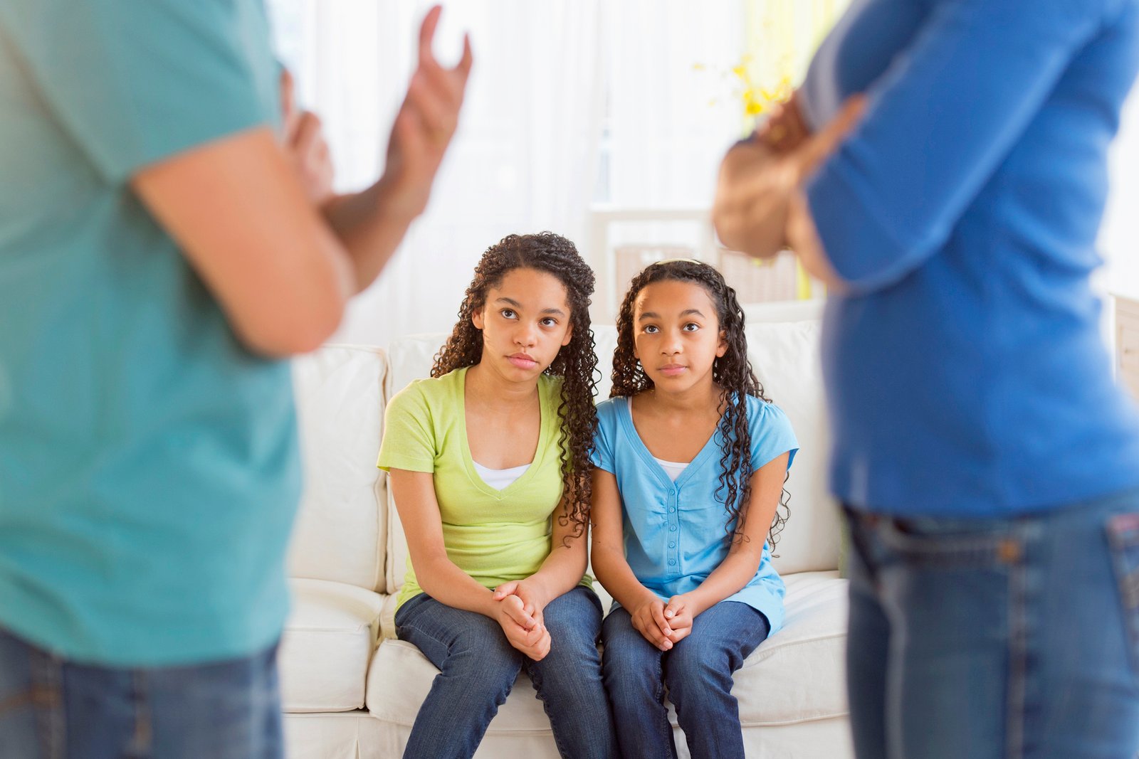 USA, New Jersey, Jersey City, Parents quarreling, with daughters (10-13) in background
